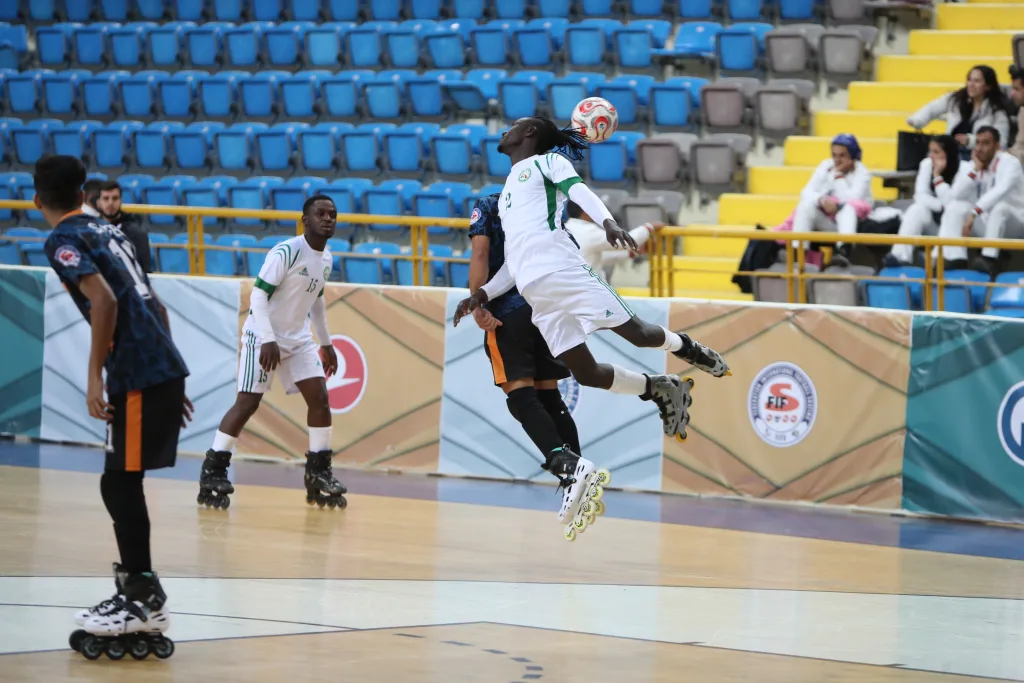 Players challenging for the ball in the air during World Cup competition