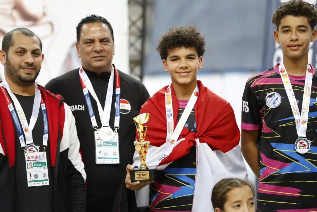 Coaches with their medal-winning young athletes after an international Football Skating final