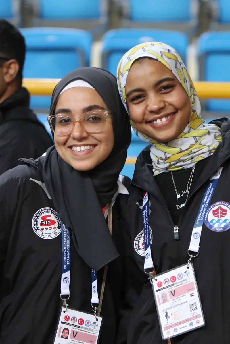 Two young officials on duty at an international Football Skating competition