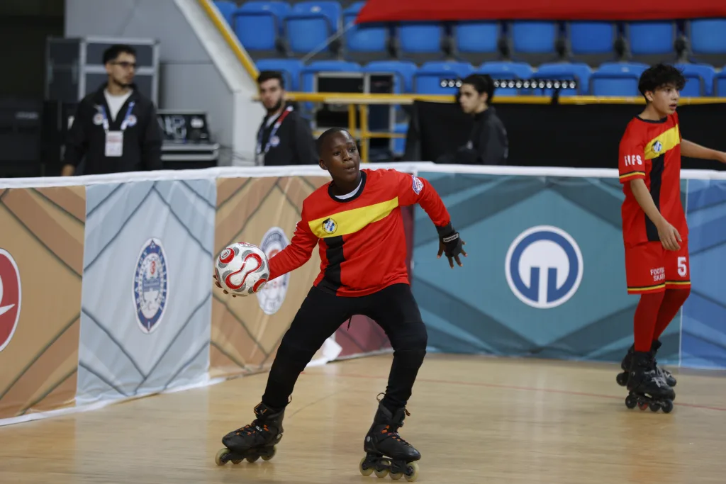 Junior players contesting the ball on skates during the Junior Football Skating World Cup