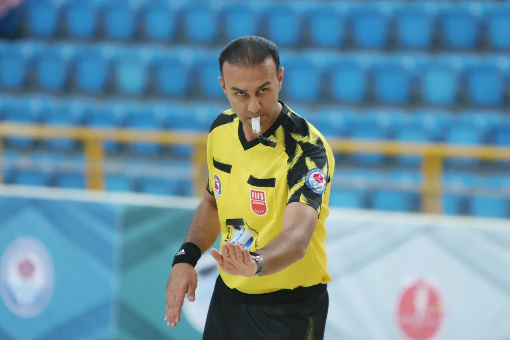 A FIFS referee signalling a decision during an international Football Skating match