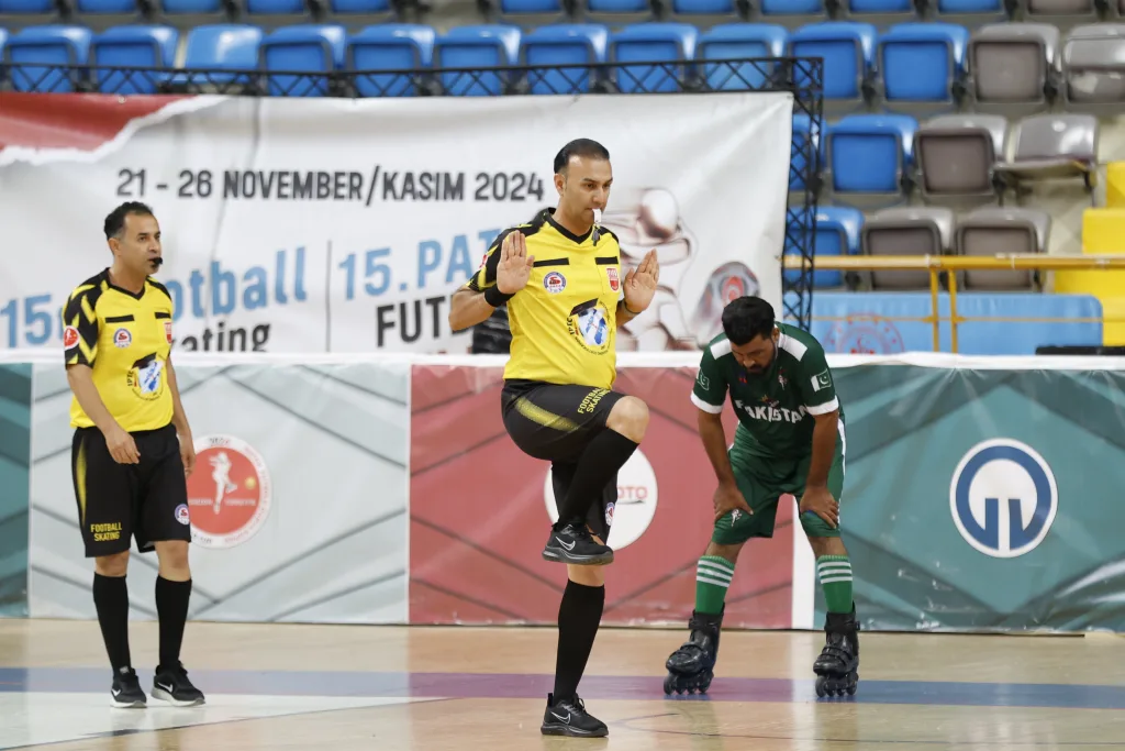A referee following play closely during World Cup competition