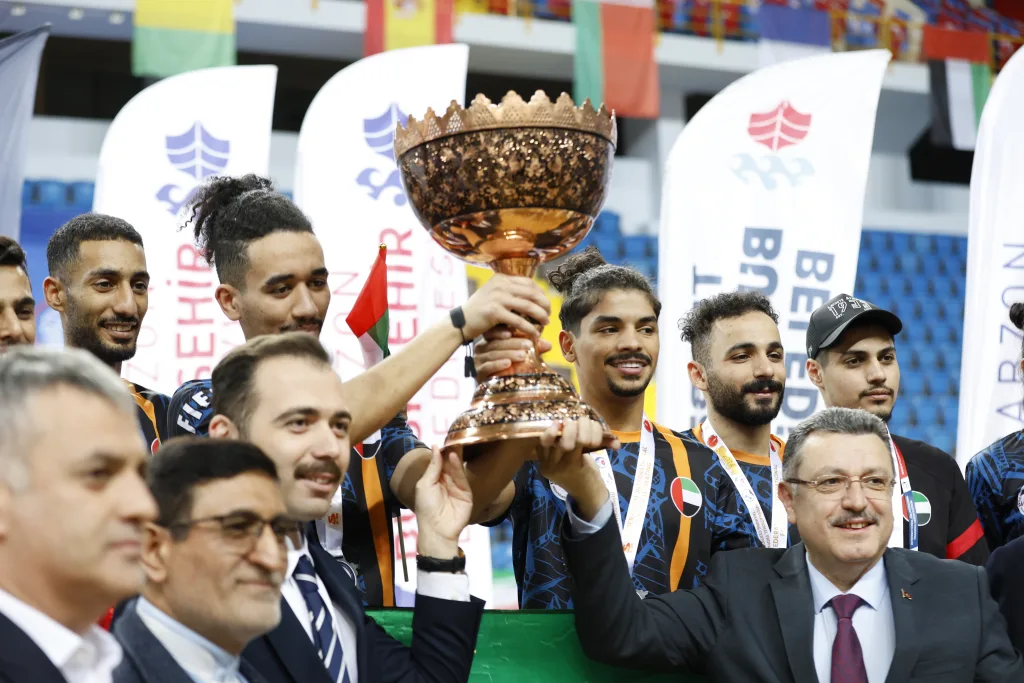 Champions with the World Cup trophy together with federation and city officials