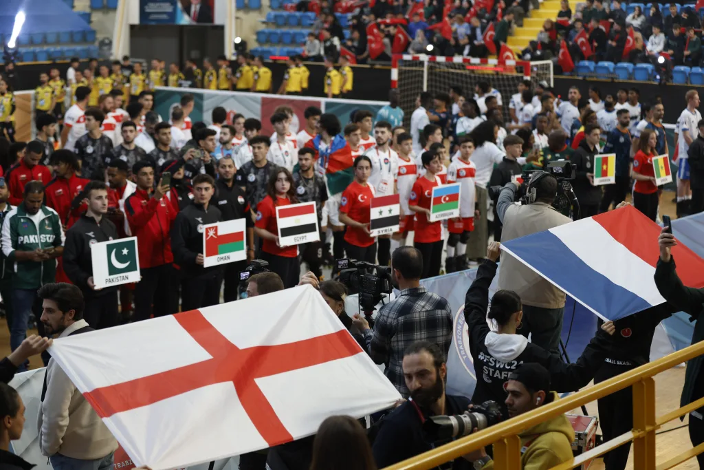 Supporters holding national flags in the stands at the Football Skating World Cup