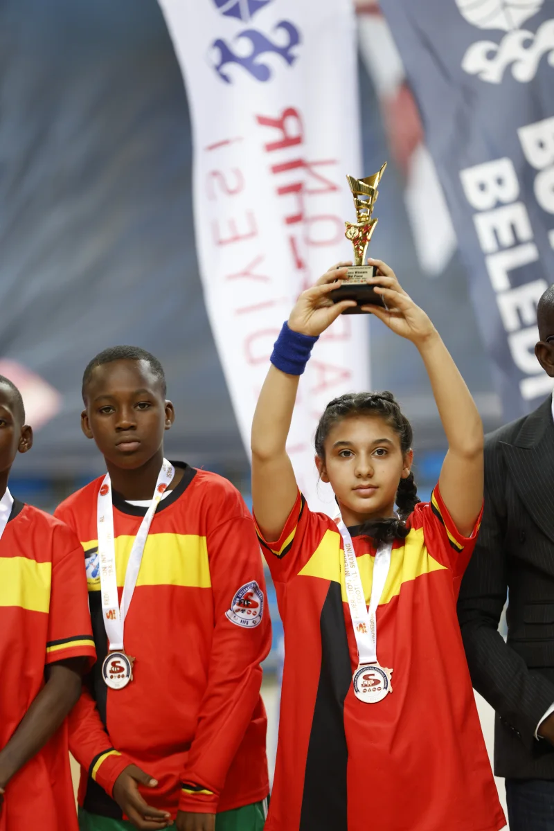 Junior World Cup medallists holding their trophy on the podium