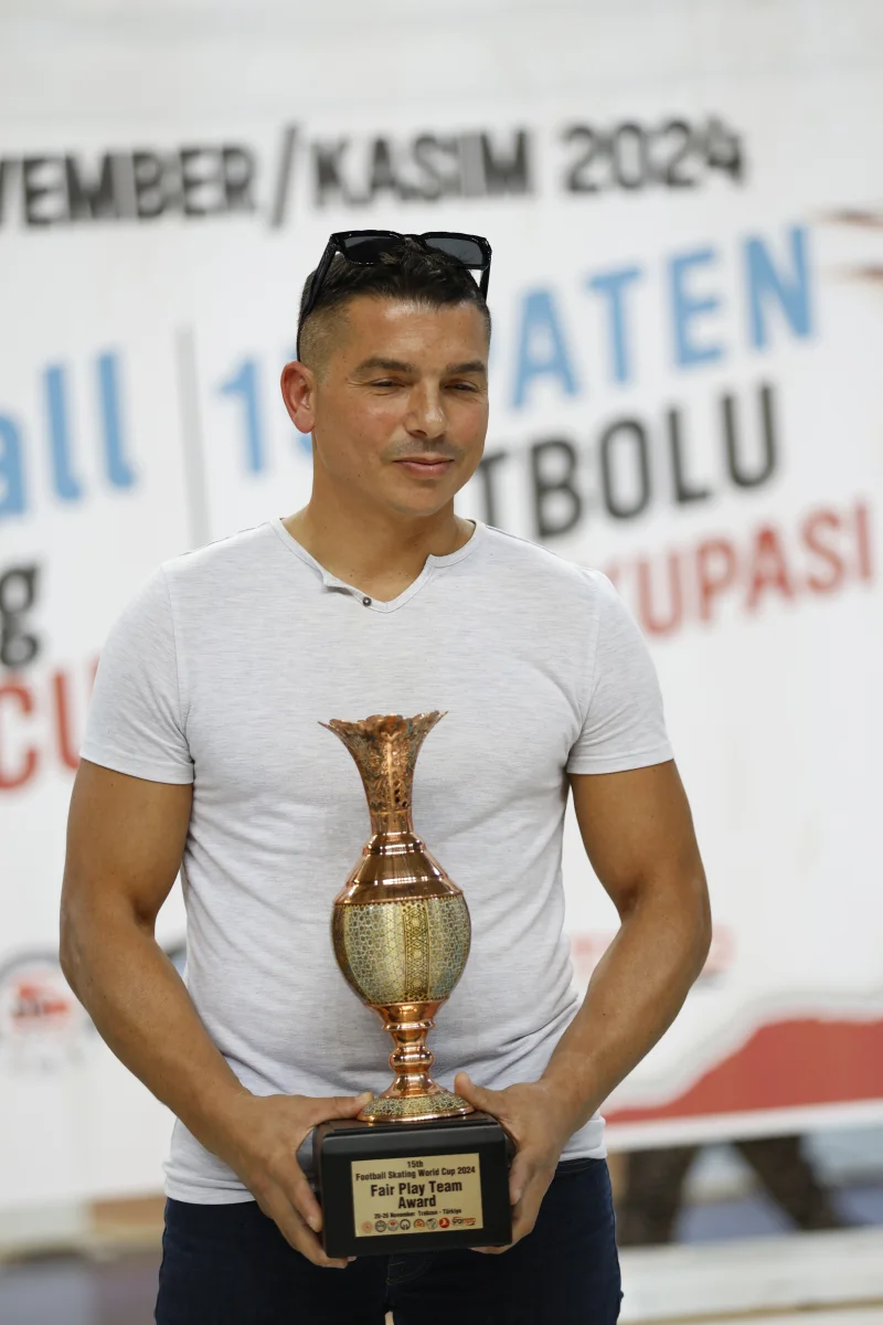 A club competition winner holding his trophy