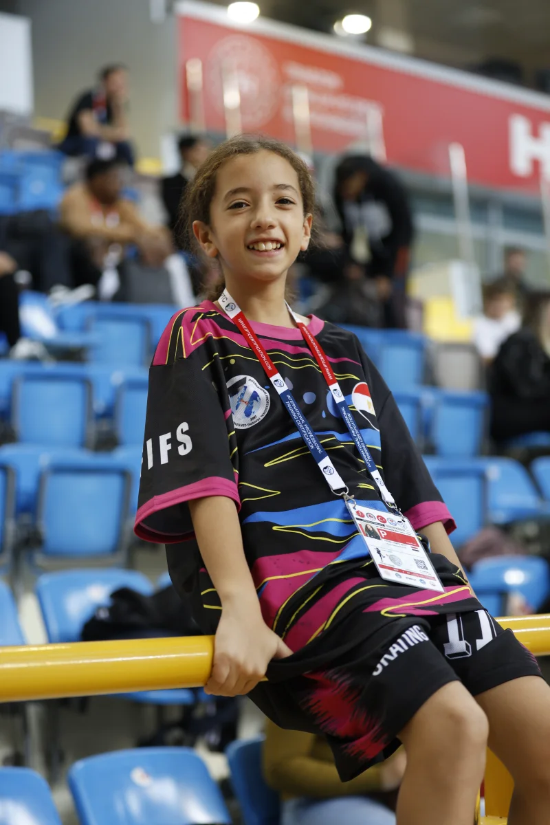 A young girl in a Football Skating team kit at an international tournament