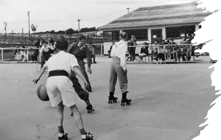 Archival black and white photograph of an outdoor football match played on roller skates