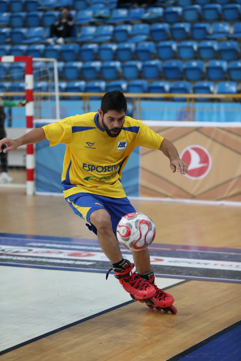 A Brazilian player striking the ball on inline skates during international competition