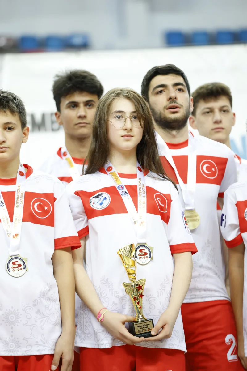 Players of Türkiye holding the trophy after winning the first Junior Football Skating World Cup