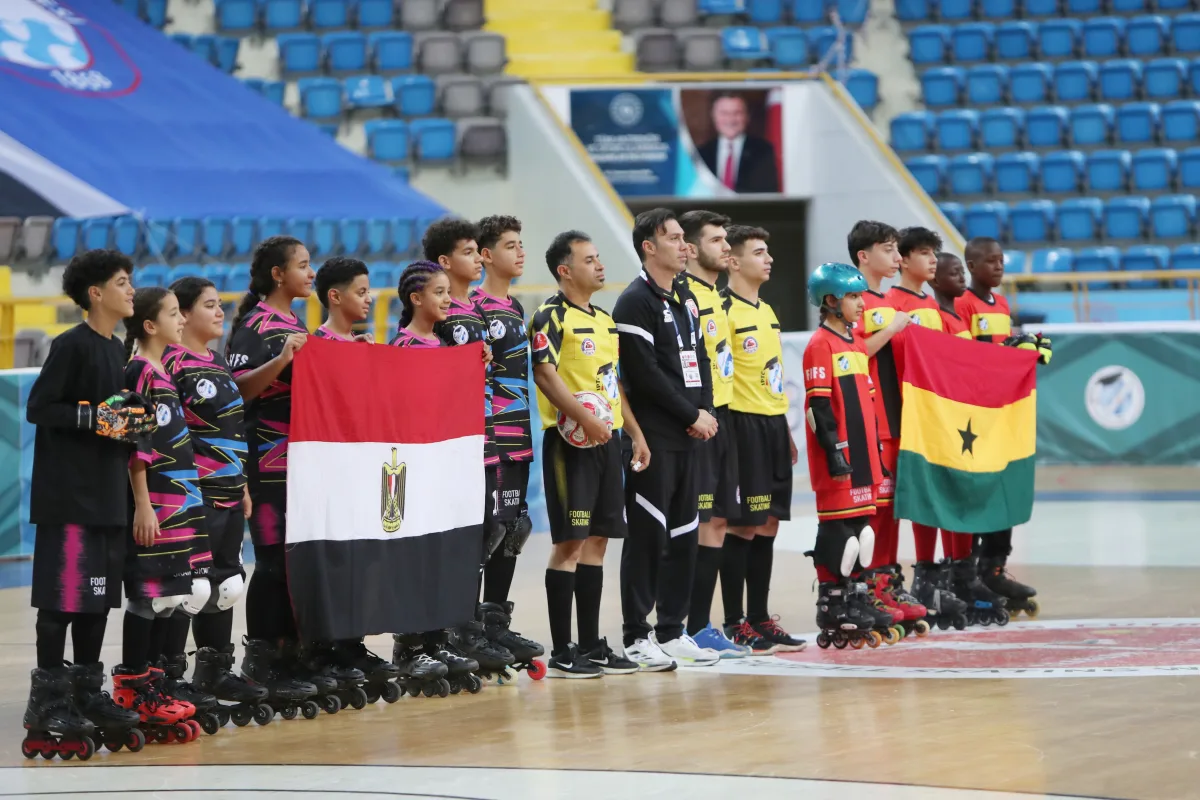Junior national teams presented with their flags and the match officials before a Junior Football Skating World Cup match