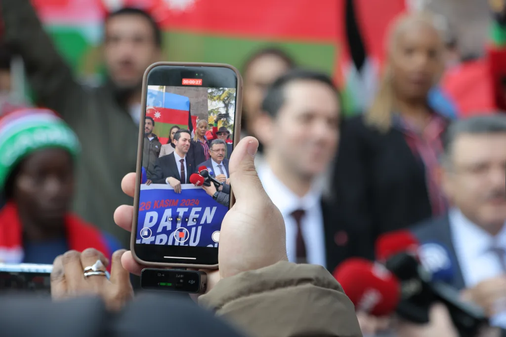 Supporters filming the FIFS President on a mobile phone in the arena during the Football Skating World Cup 2024